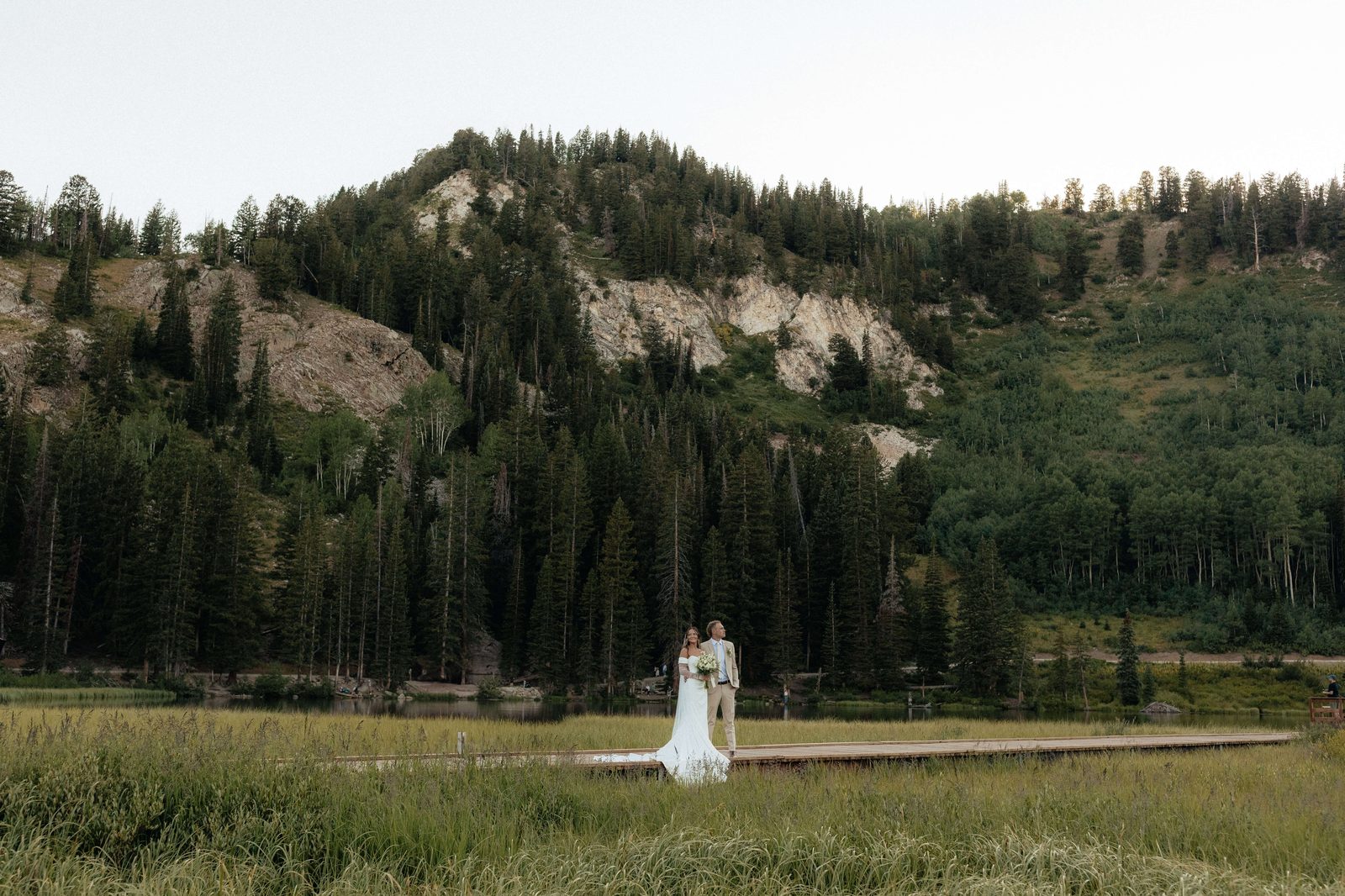 Bride in mountain meadow at golden hour, Utah